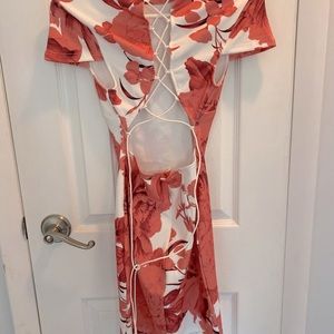 Women’s white dress with coral floral design.